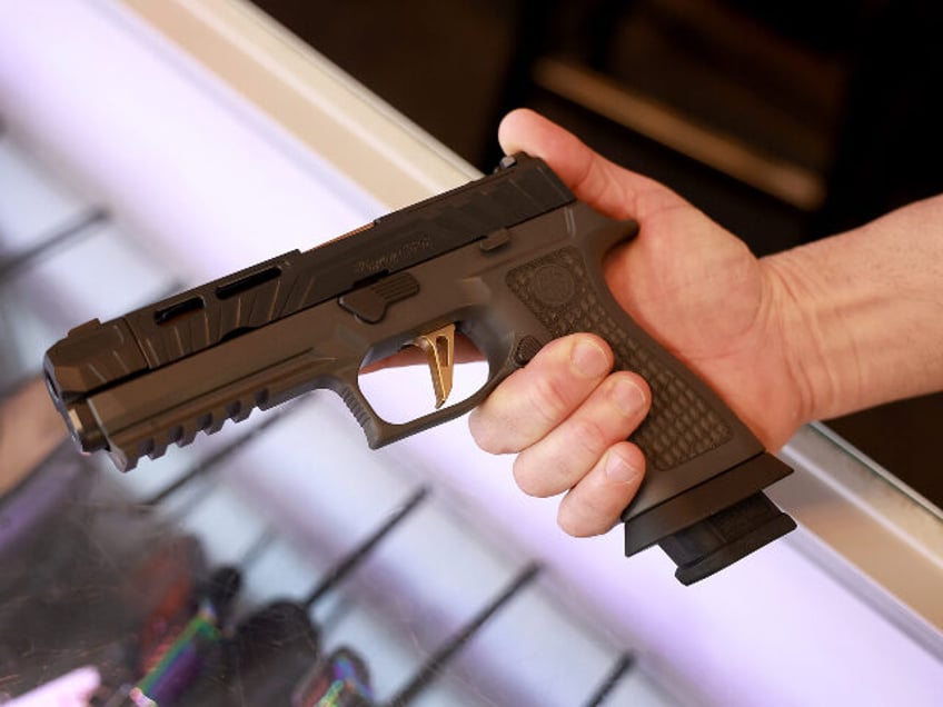 A Sig Sauer P320 handgun is held at the WEX Gunworks store on January 31, 2023 in Delray B