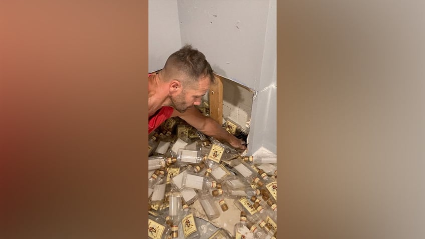 new jersey couple uncovers hidden stash of empty rum bottles behind basement wall its 5 oclock somewhere