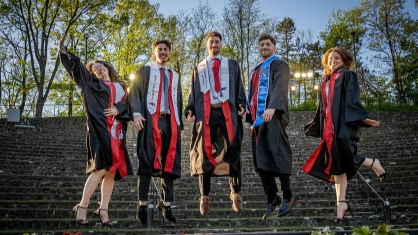 Siblings wearing regalia