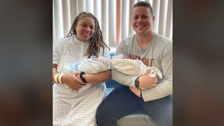 Parents holding newborn twins