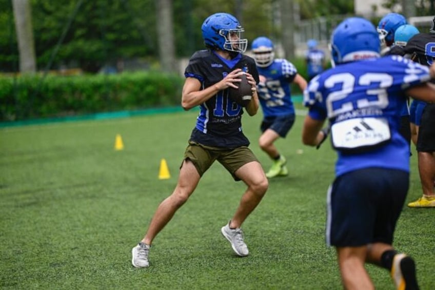 An American football player holds the ball during a training session of the Rio Football A