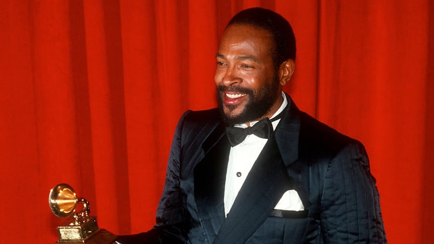Marvin Gaye smiling and holding a Grammy