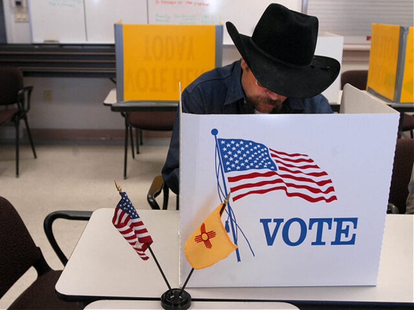 Mario Romero of Pojoaque, New Mexico, fills out his ballot during early voting at the Pojo