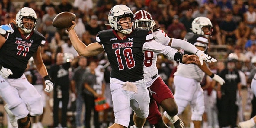 new mexico states diego pavia tries to make play with helmet twisted around