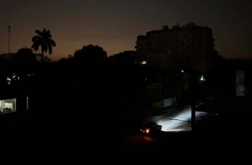 Car lights illuminate a street in Havana, Cuba during a widespread electricty blackout tha