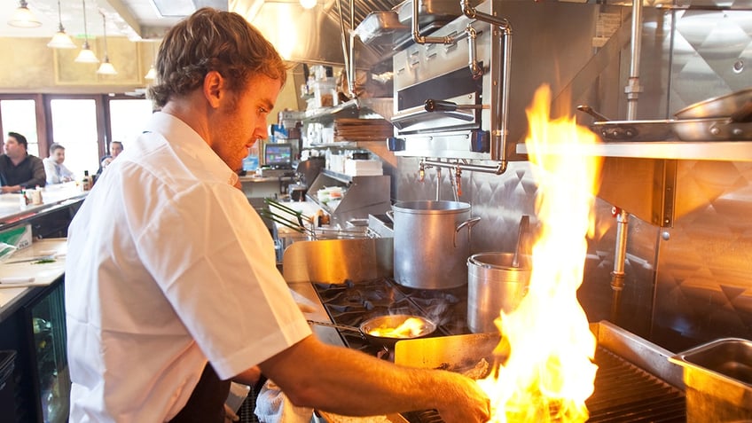 Jeramie Robinson, chef of Zimm's Little Deck, prepares char-grilled oysters Wednesday, Oct. 27, 2010, in Houston. 