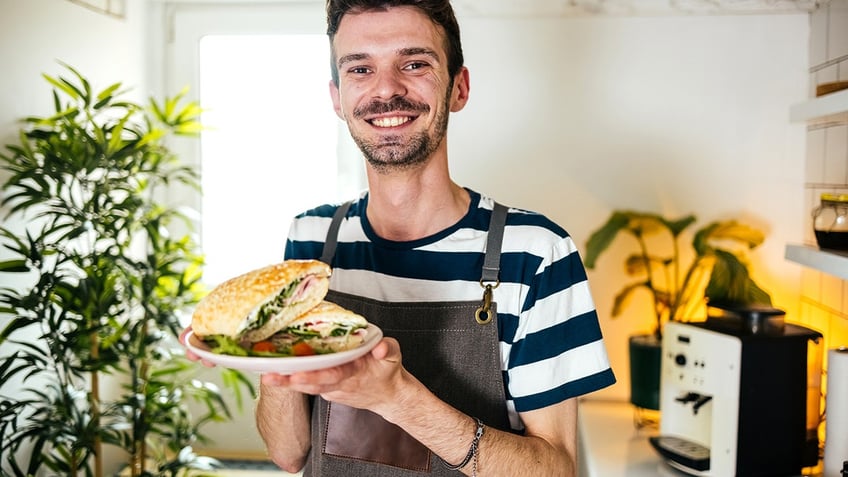 Man holding a sandwich.