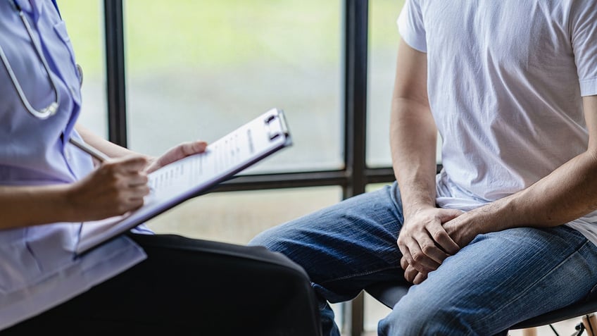 male patient meets with doctor