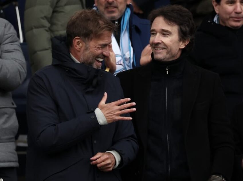 German football coach Jurgen Klopp (R) and Antoine Arnault (L), whose family have purchase