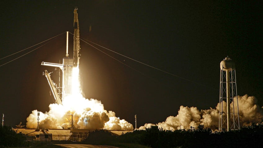 Fire and smoke billows from a SpaceX Falcon 9 as it blasts off with four private citizens from pad 39A at the Kennedy Space Center in Cape Canaveral, Florida.