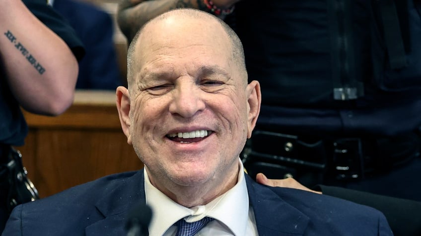 Harvey Weinstein shows off his smile in court