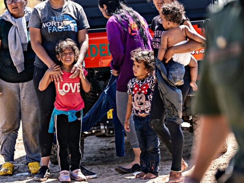 EAGLE PASS, TEXAS - SEPTEMBER 28: An immigrant child is overcome with emotion after she cr