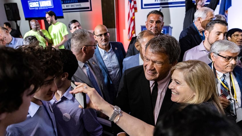 Latimer smiles for a picture with a supporter