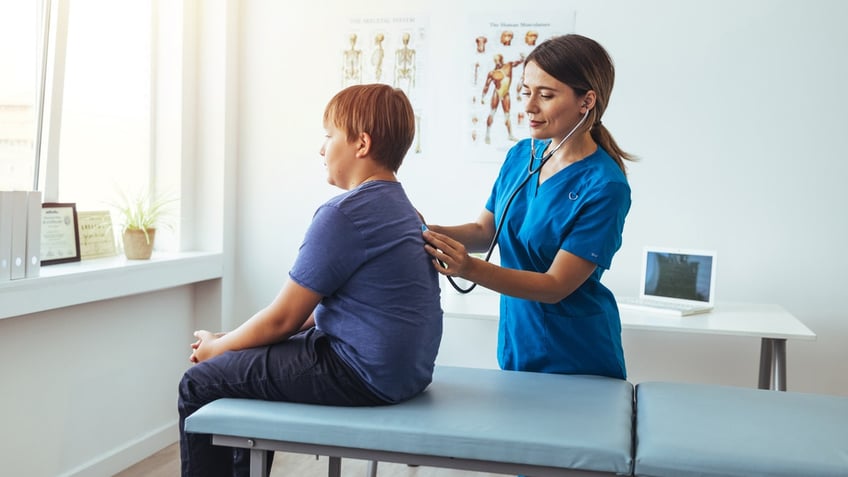 Teen boy with doctor