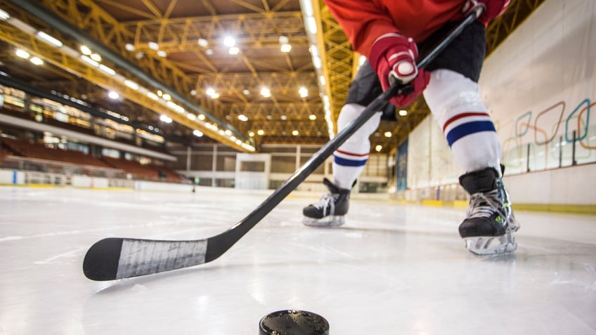 a photo of a hockey player shooting a puck
