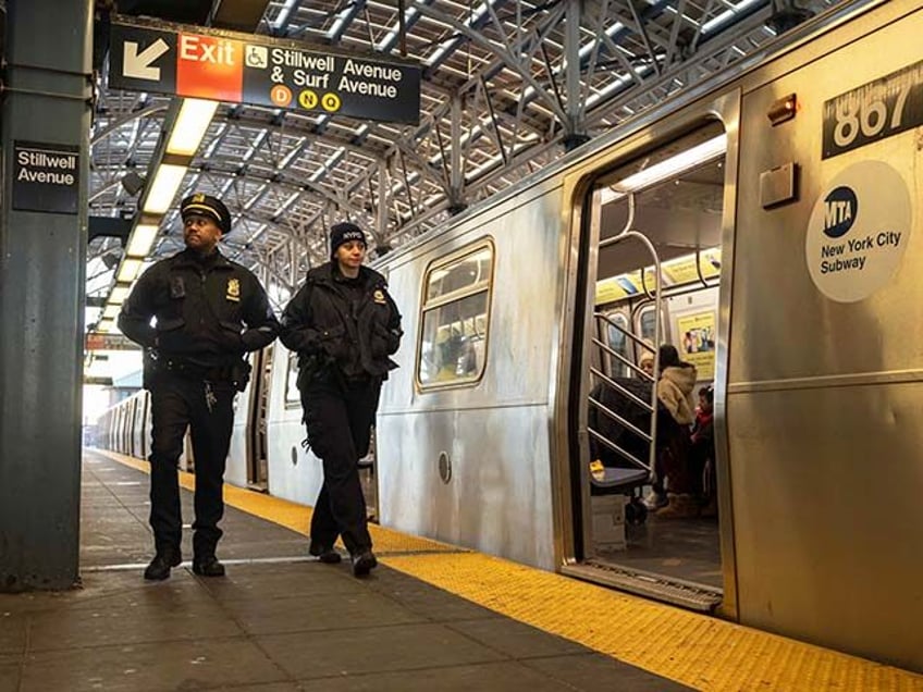 Police officers patrol the F train platform at the Coney Island-Stillwell Avenue Station,