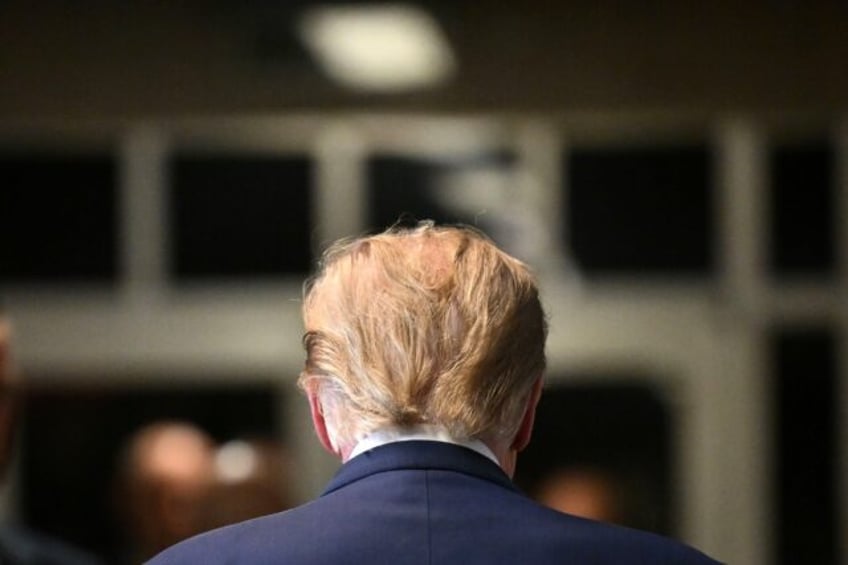 Former US President Donald Trump walks to the courtroom after speaking to the press at Man