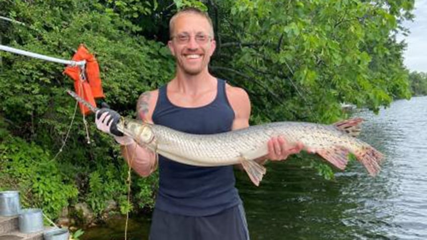 Chuck Zimmerman holding longnose gar