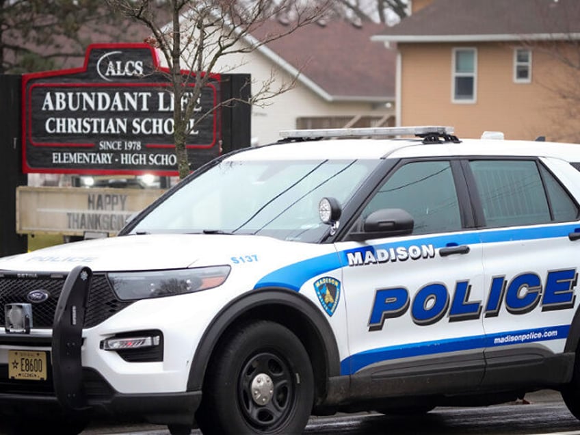 Emergency vehicles are parked outside the Abundant Life Christian School in Madison, Wis.,