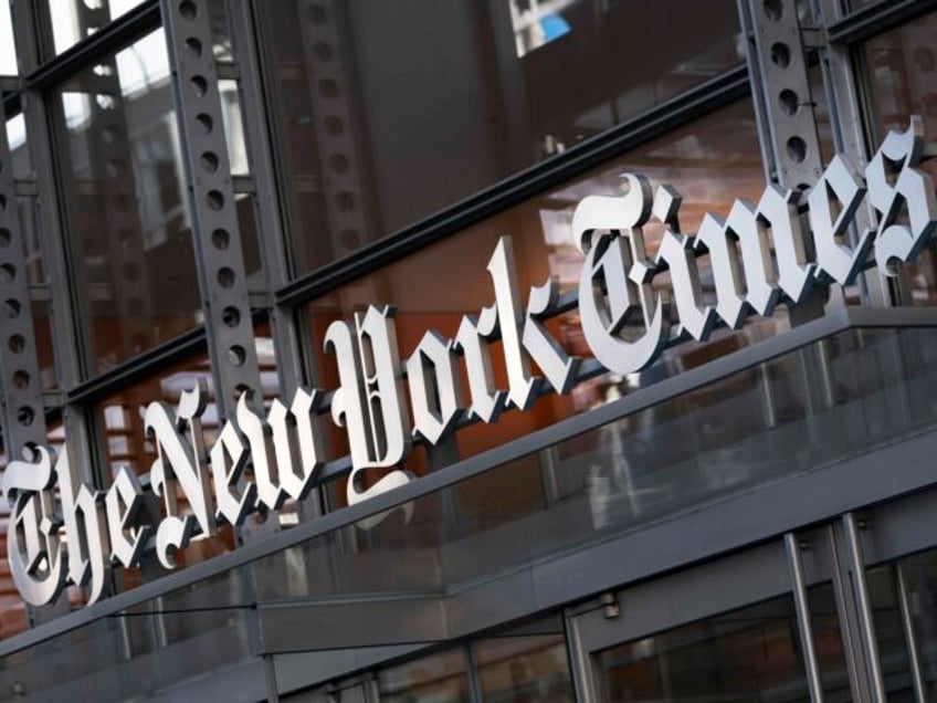 FILE - A sign for The New York Times hangs above the entrance to its building, May 6, 2021