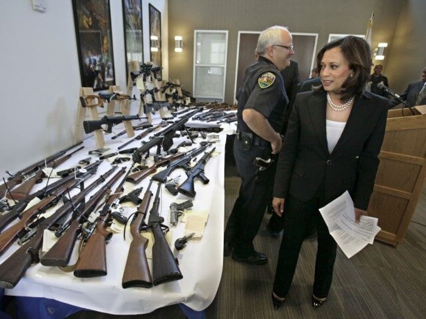 In this June 16, 2011 file photo, Attorney General Kamala Harris looks over some of the gu