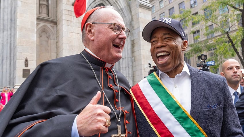 Cardinal Dolan and Eric Adams laugh