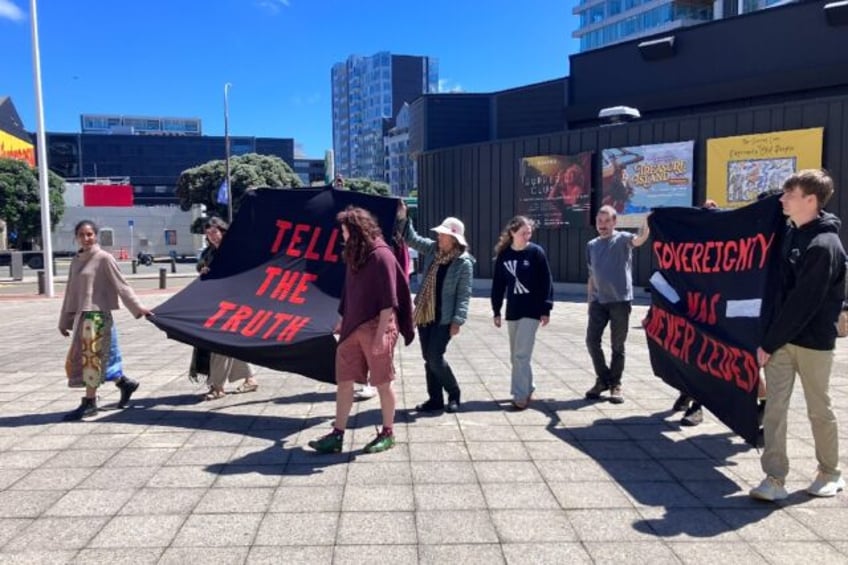 Protestors from the Te Waka Hourua group walk after defacing a historic exhibit at New Zealand’s National Museum