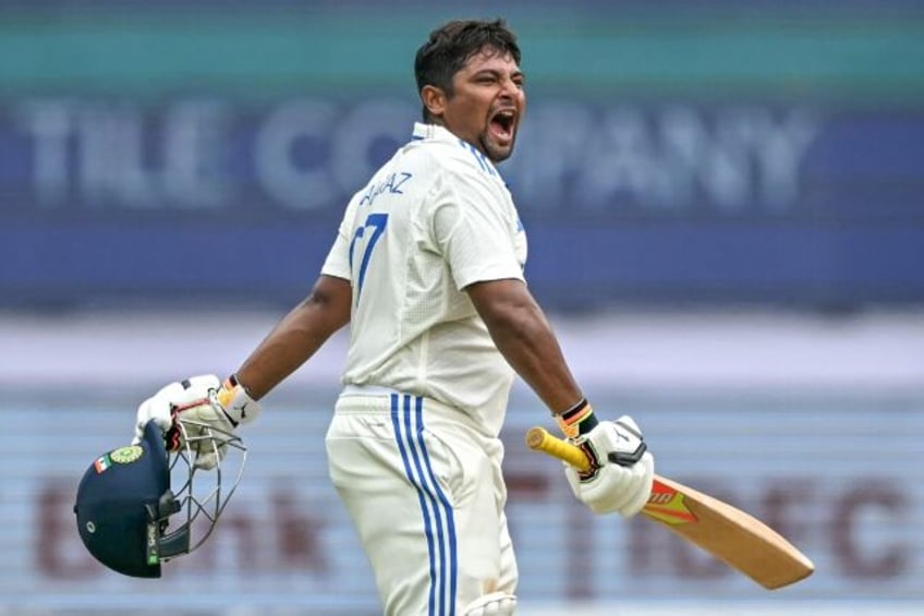 India's Sarfaraz Khan celebrates after scoring a century on the fourth day of the first cr