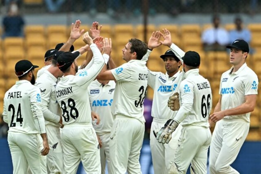 New Zealand's players celebrate after the dismissal of India's captain Rohit Sharma