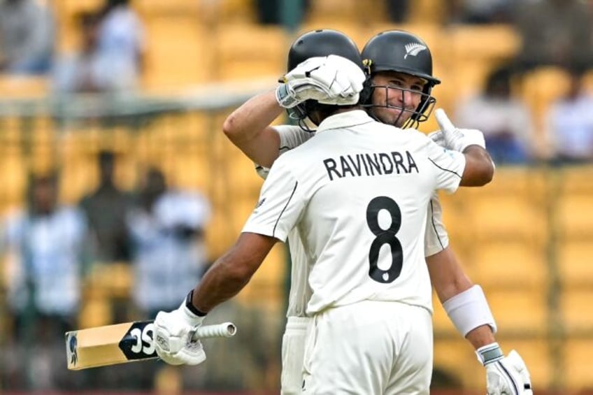 New Zealand's Will Young and Rachin Ravindra celebrate their team's win against India