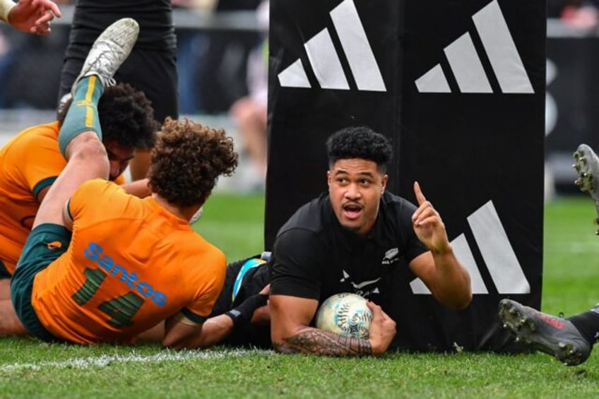 New Zealand's Leicester Fainga’anuku (R) celebrates scoring a try against Australia last