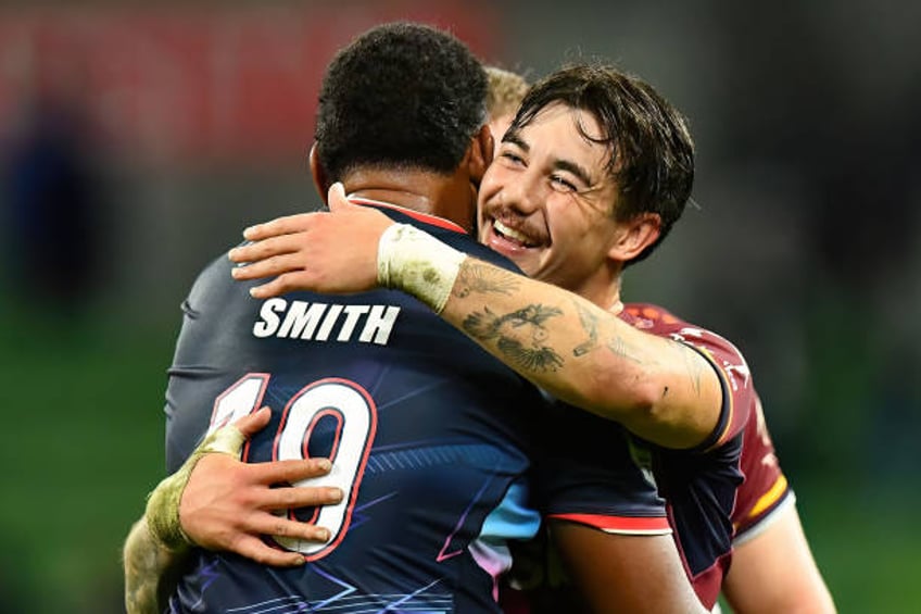 Connor Garden-Bachop of the Highlanders and Angelo Smith of the Rebels hug following the round eight Super Rugby Pacific match between Melbourne...