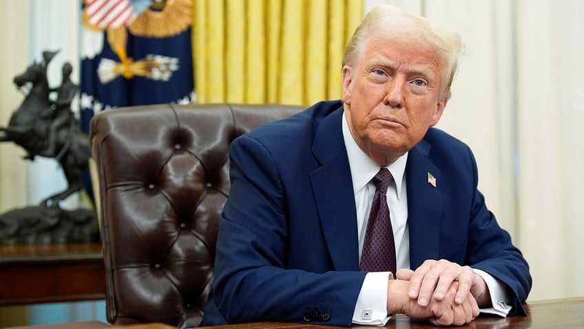 President Donald Trump seated