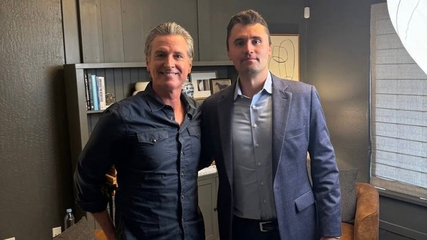 Gov. Newsom posing with Charlie Kirk, right