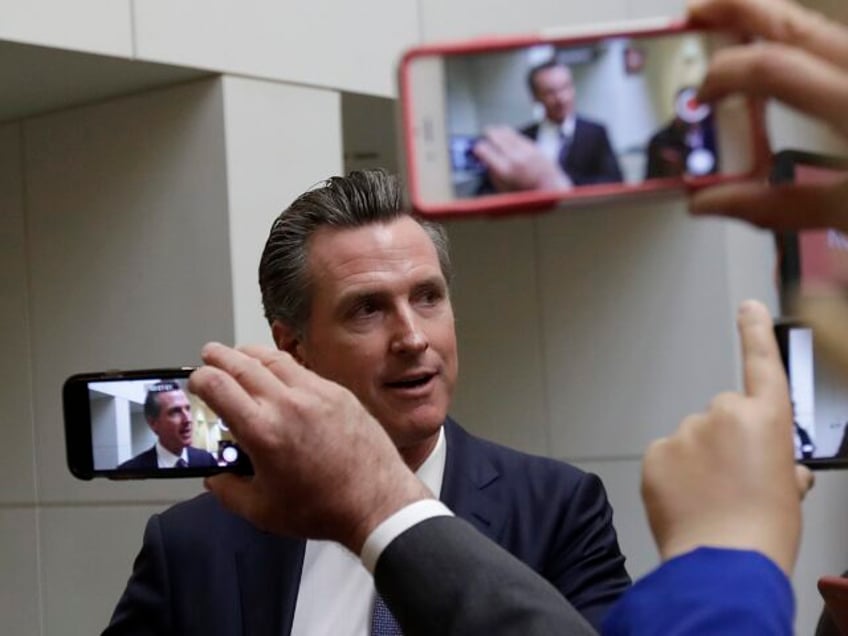 Democratic candidate Gavin Newsom speaks with reporters after a California gubernatorial d