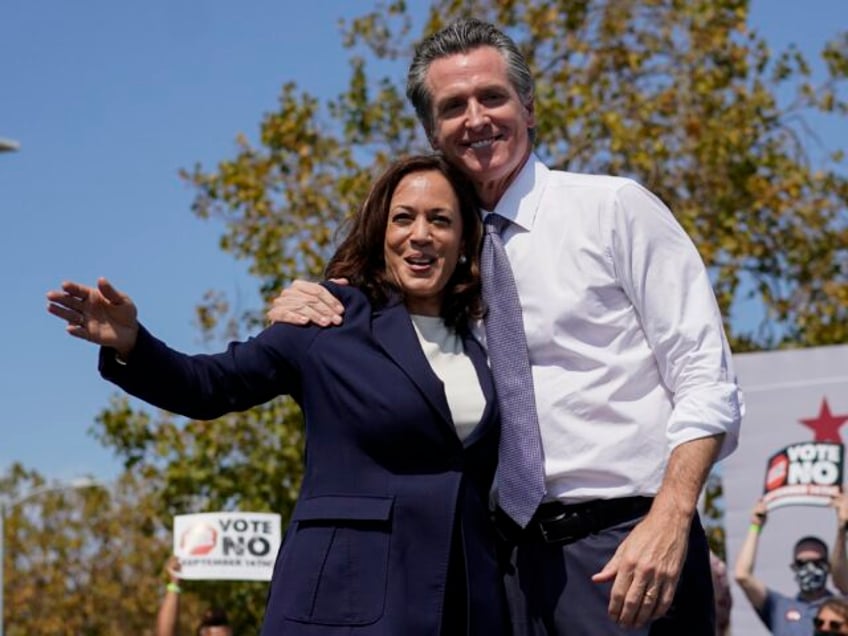 Vice President Kamala Harris stands on stage with California Gov. Gavin Newsom at the conc