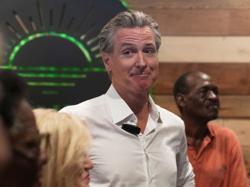 Gov. Gavin Newsom, D-Calif., waits to speak to a crowd at a coffee shop during a two-day s
