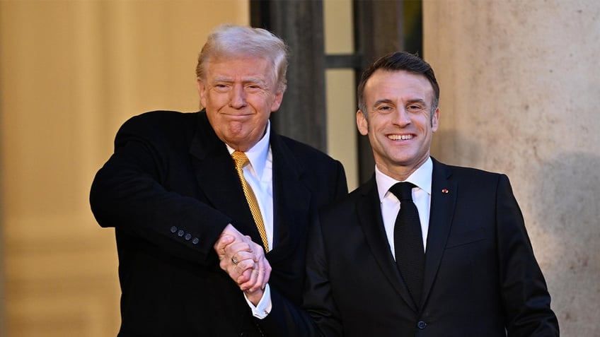 PARIS, FRANCE - DECEMBER 07: French President Emmanuel Macron (R) shakes hands as he welcomes US President-elect Donald Trump (L) before a meeting at the Elysee Presidential Palace in Paris, France on December 7, 2024 (Photo by Mustafa Yalcin/Anadolu via Getty Images)