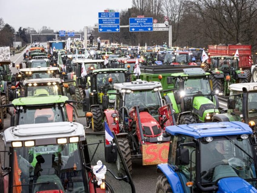 STRASBOURG, FRANCE - JANUARY 30: Farmers take part in a protest called by local branches of major farmer unions FNSEA and Jeunes Agriculteurs, blocking the A35 highway with tractors near Strasbourg, France, on January 30, 2024. Protests continue nationwide, called by several farmers unions on pay, tax and regulations. (Photo …