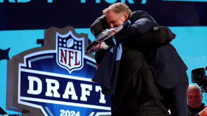 JC Latham hugs Roger Goodell