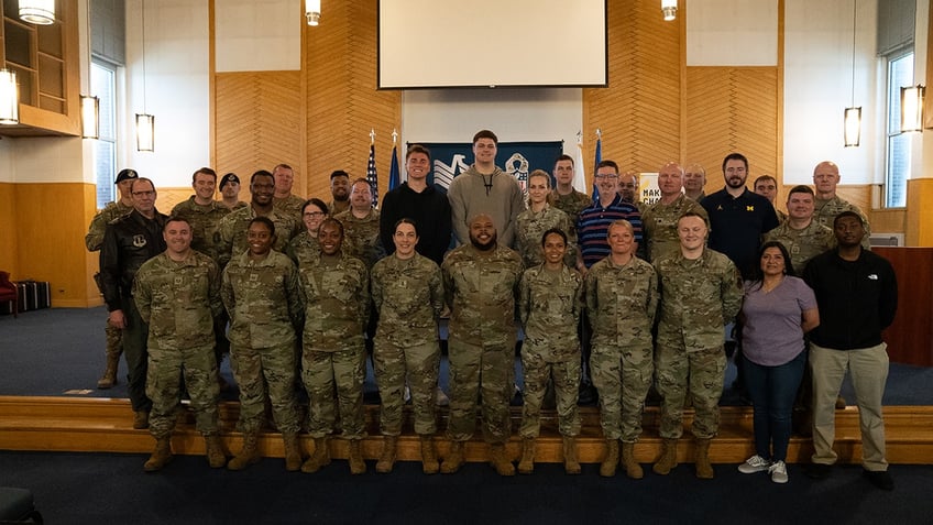 Joe Alt and Bo Nix pose with Selfridge National Guard members