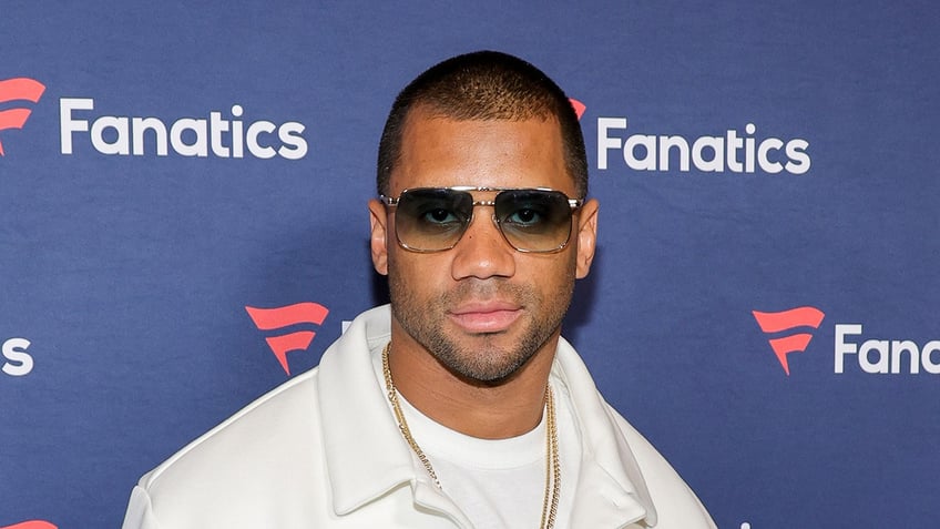 Russell Wilson poses on red carpet