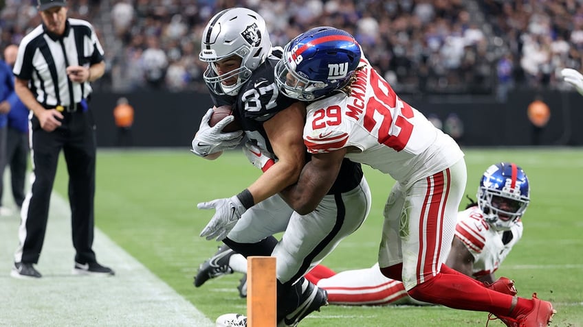 Xavier McKinney makes a tackle