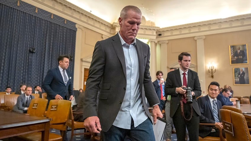 Brett Favre enters the chambers