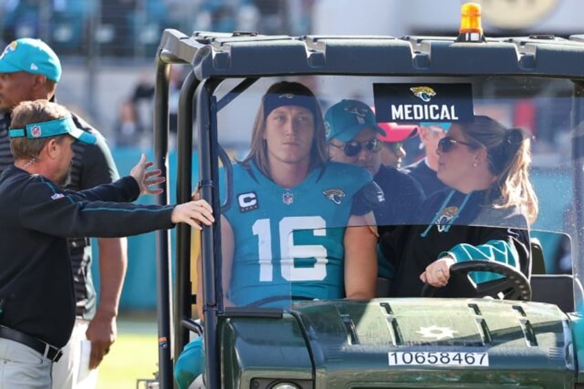 Jacksonville Jaguars quarterback Trevor Lawrence, taken off the field after receiving a co