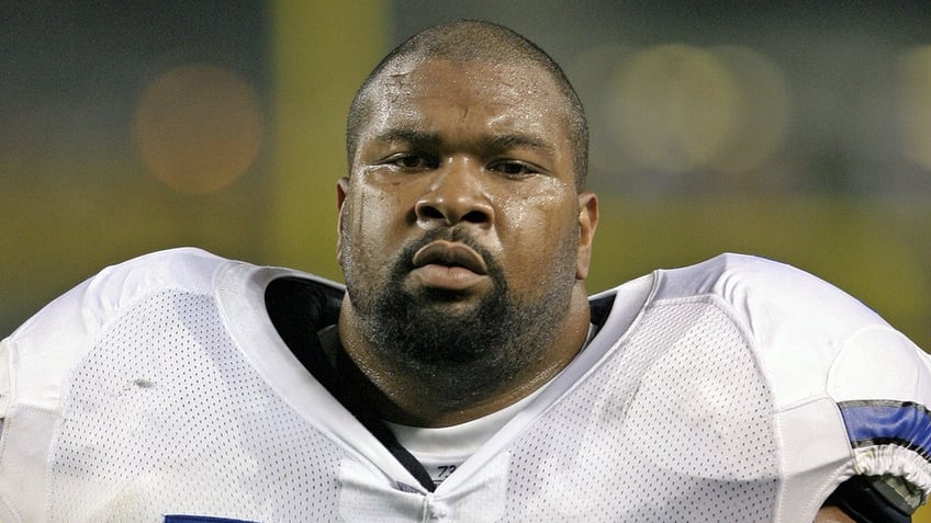 Larry Allen looks on