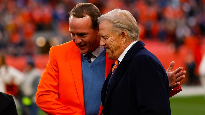 Former Broncos quarterbacks John Elway and Peyton Manning