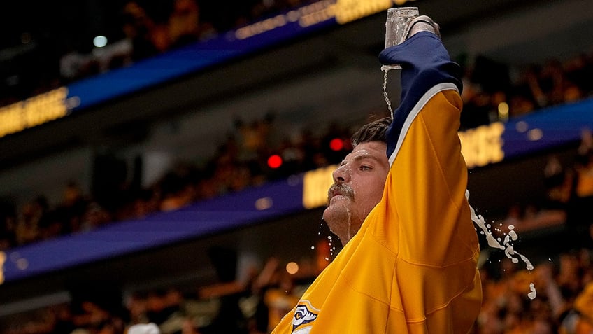 Taylor Lewan pours beer on his head