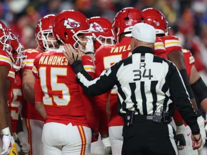 KANSAS CITY, MO - JANUARY 26: Referee Carl Cheffers (34) puts his hand on the back of Kans