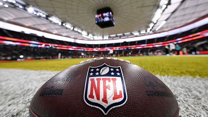 An NFL football on the turf